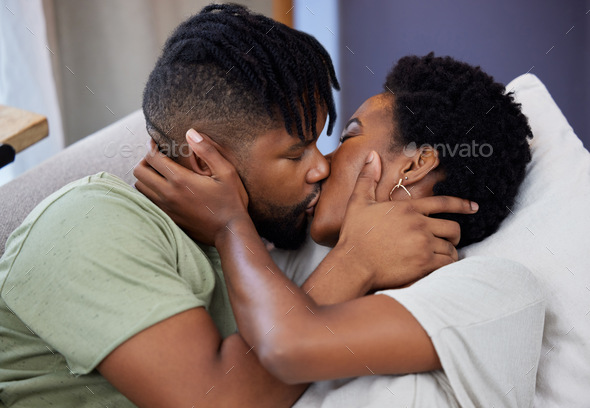 Nothing sweeter than a kiss from the one you love. Shot of a young couple kissing at home.