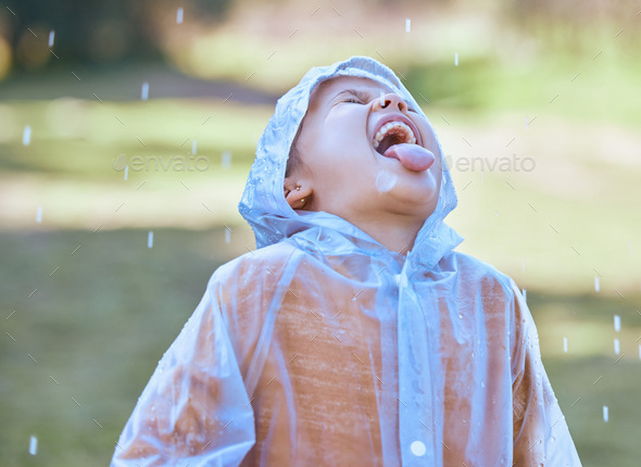 Shot of a little girl sticking her tongue out to catch the rain drops in her mouth
