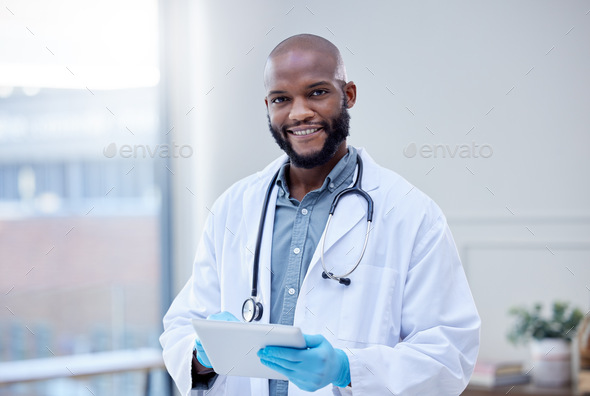 Use the app to make an appointment. Shot of a male doctor using a digital tablet.