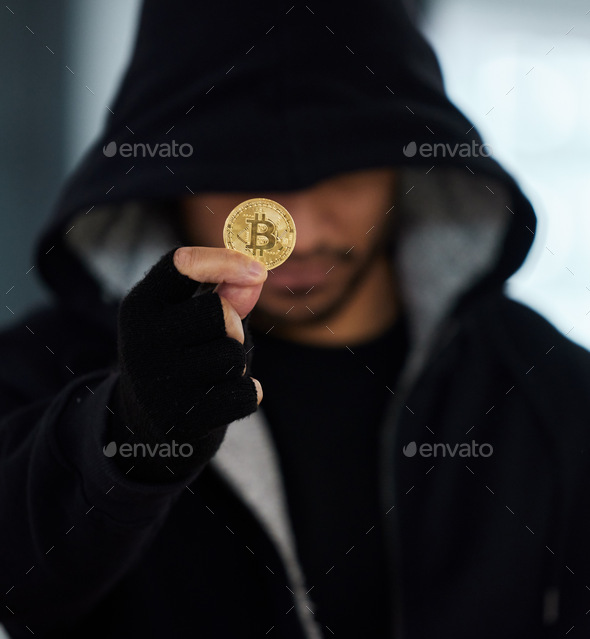 No digital print will be left behind. Shot of a scammer holding a bitcoin.