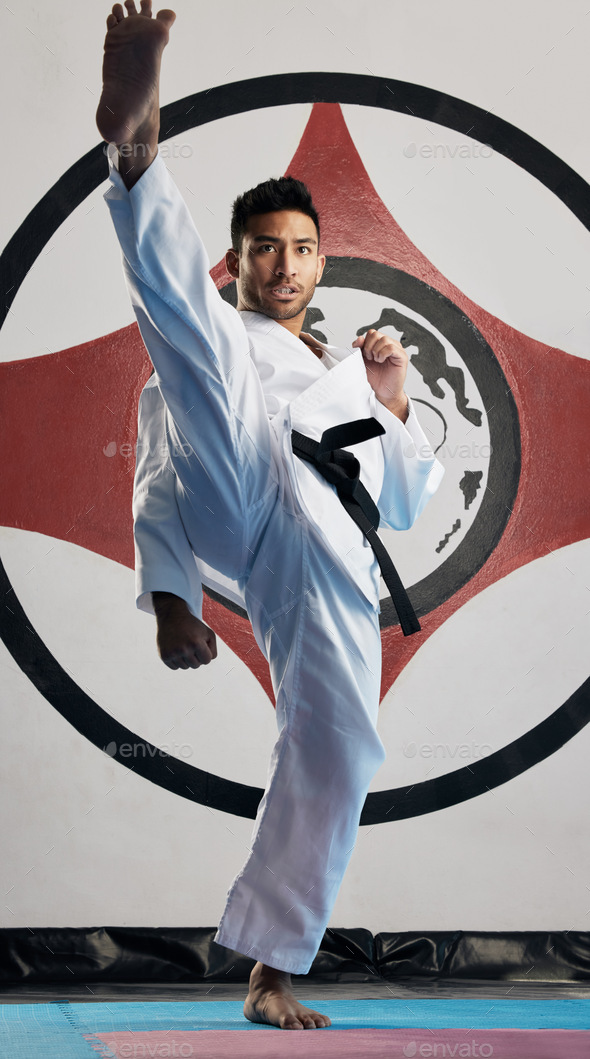 Kiai. Full length portrait of a handsome young martial artist