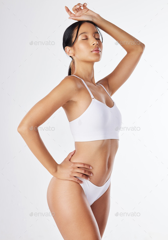 Shot of a young woman posing in her underwear against a white background  Stock Photo by YuriArcursPeopleimages