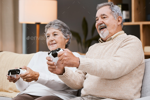 Happy Couple Sitting On The Sofa Playing Video Games Using