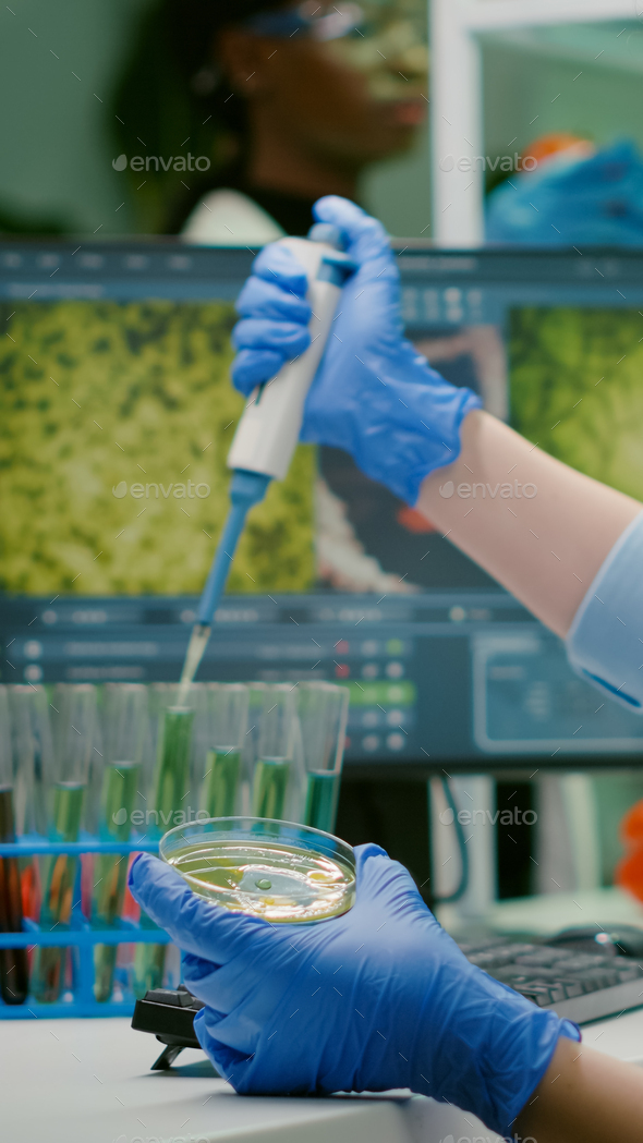 Scientist woman taking solution from test tube with
