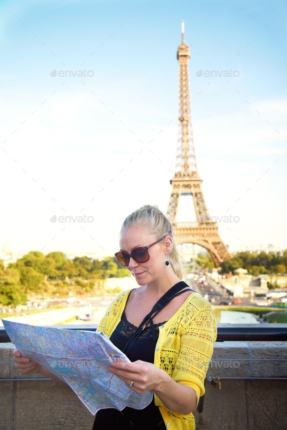 How do I get to the tower. An attractive young woman holding a map while sight seeing in the Paris.