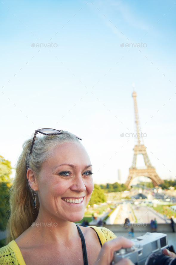 Portrait of a beautiful young woman taking photos while sight seeing in the Paris
