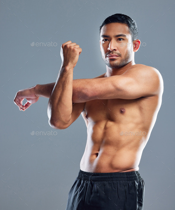 Premium Photo  Ill keep making muscles. studio shot of a muscular young  man posing with his arms crossed against a grey background.