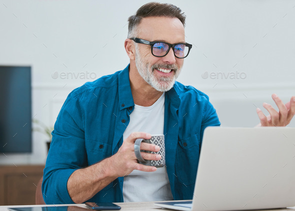 Good news is the order of the day. Shot of a mature businessman working from home using his laptop.