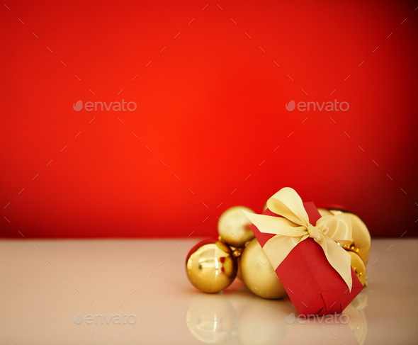 Its a special time of year. Studio shot of Christmas ornaments against a red background.