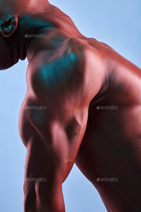 Put in the work and lift heavy. Shot of a muscular man posing against a studio background.