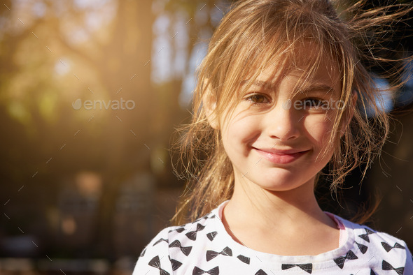 Nothing but carefree days. Portrait of a little girl enjoying some time outdoors.
