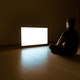 The man sitting on the floor in front of the television in the dark room - PhotoDune Item for Sale