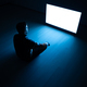 The man sitting in the dark room in front of a white screen - PhotoDune Item for Sale
