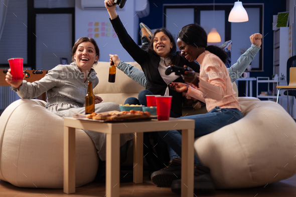 Multiethnic group of people playing online video games on tv