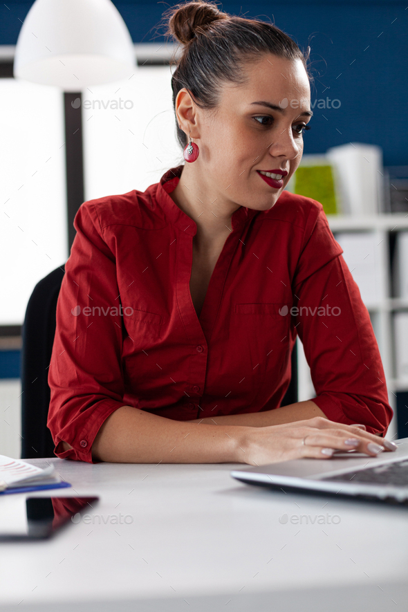 Company director looking through documents on laptop