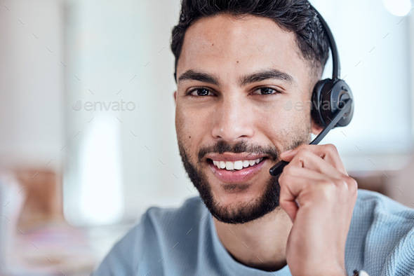 This is where we make dreams come true. Shot of a handsome young man working in a call center.