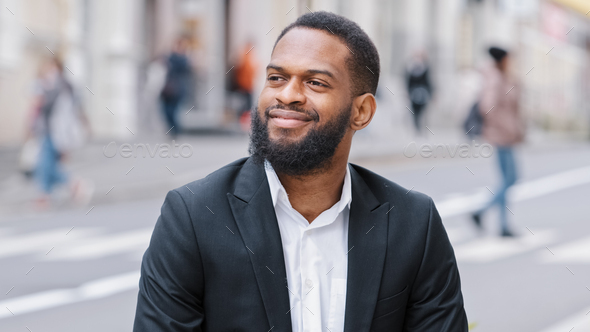 Closeup portrait bearded ethnic man employer dreaming thinking outdoors. African American 30s