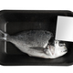 fresh sea bream in black black vacuum packaging with blank white label isolated on background - PhotoDune Item for Sale