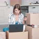 Woman Pays Online Sitting in the Kitchen - VideoHive Item for Sale