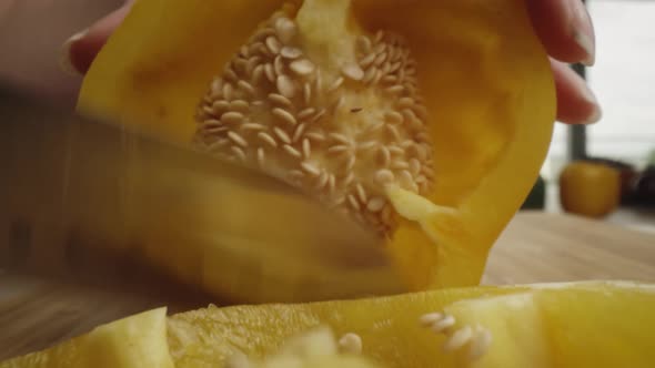 Zoom out macro video of cut yellow pepper. Shot with RED helium camera in 8K alt