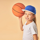 Cheerful cute girl in cap plying basketball - PhotoDune Item for Sale