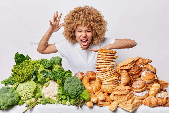 Indoor Curly Haired Woman Gestures And Screams Angrily Keeps Mouth