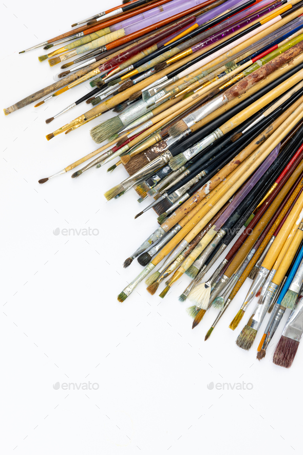 Many brushes for painting on a white background, top view. Stock Photo by  puhimec