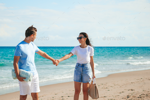 Young couple in love on the beach summer vacation. Happy man and woman enjoy time together - Stock Photo - Images