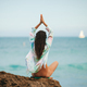 Young woman with practicing yoga on the beach - PhotoDune Item for Sale