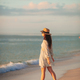 Young beautiful woman at straw hat on the beach at sunset - PhotoDune Item for Sale