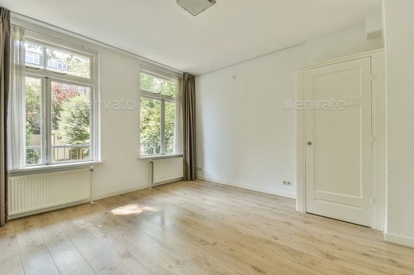 Interior of empty room with windows and curtain
