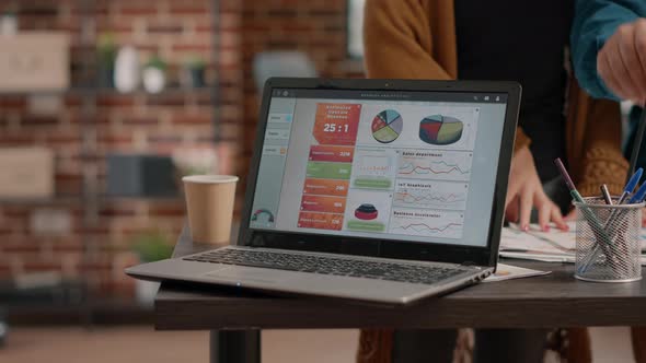 Close Up of Laptop with Chart Rate Information on Desk alt