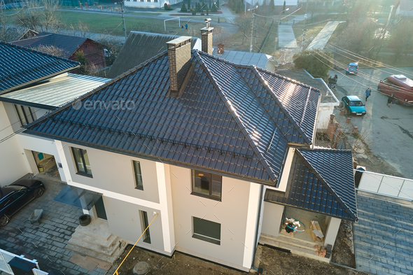 Aerial view of private house with ceramic shingles covered roof top.