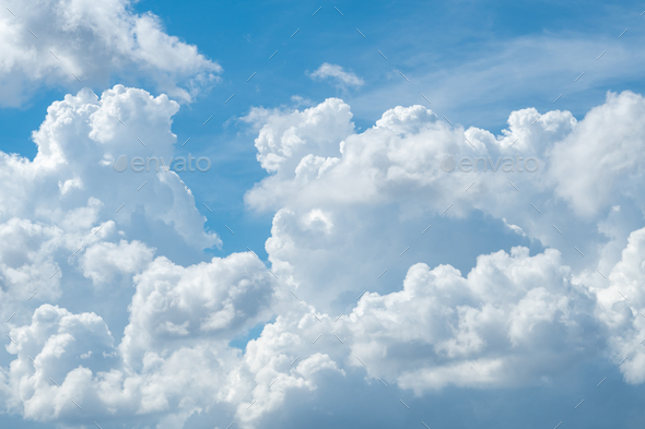 White fluffy clouds on blue sky. Soft touch feeling like cotton. White puffy cloudscape. Beauty