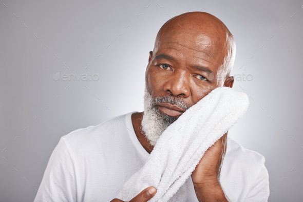 Portrait, towel or old man cleaning face in studio with marketing or mock up space for skincare bea