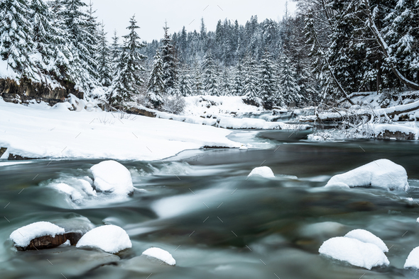 Winter landscape, snowy trees in forest and frozen river - Stock Photo - Images