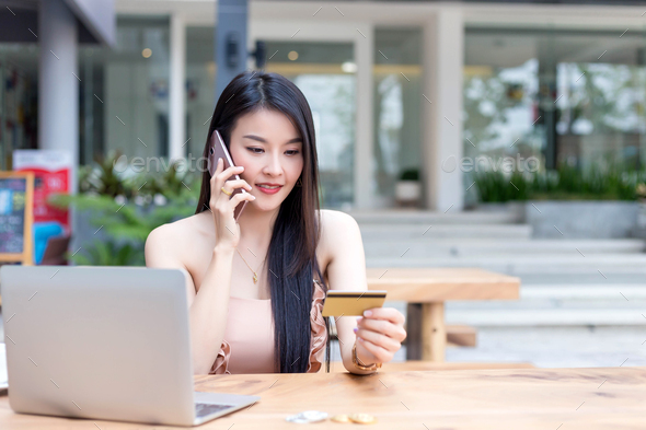 Asian woman callphone and holding credit card. Online shopping concept. - Stock Photo - Images