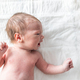 Newborn baby laying on changing table - PhotoDune Item for Sale