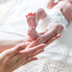 Mother using cream on body of newborn baby - PhotoDune Item for Sale