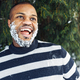 Cheerful funny African man with snow in beard enjoying winter weather - PhotoDune Item for Sale