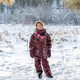 a young girl walks through a snow-covered forest in winter - PhotoDune Item for Sale