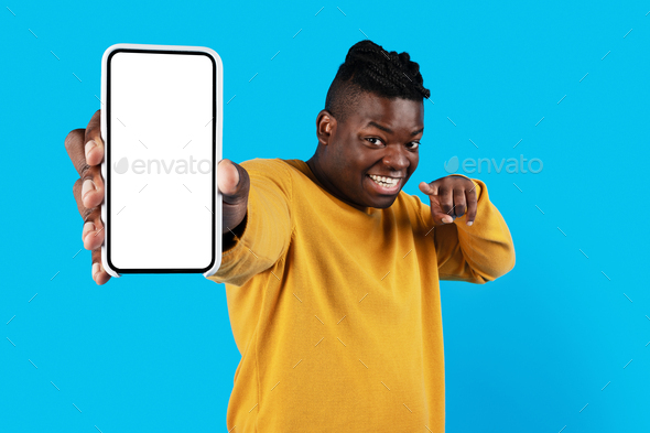 Online Ad. Smiling Black Male Pointing At Blank Smartphone In His Hand