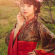 Portrait of beautiful asian woman in blooming park at sunset - PhotoDune Item for Sale