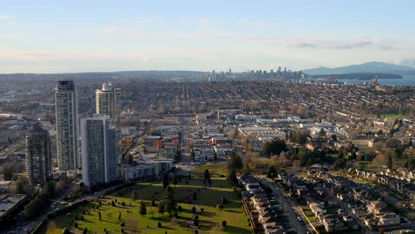Big Grassy Park Between City Centre And Residential Town In Burnaby Canada - aerial shot alt