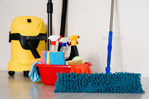 mop,yellow vacuum cleaner,plastic bucket with detergents for home cleaning