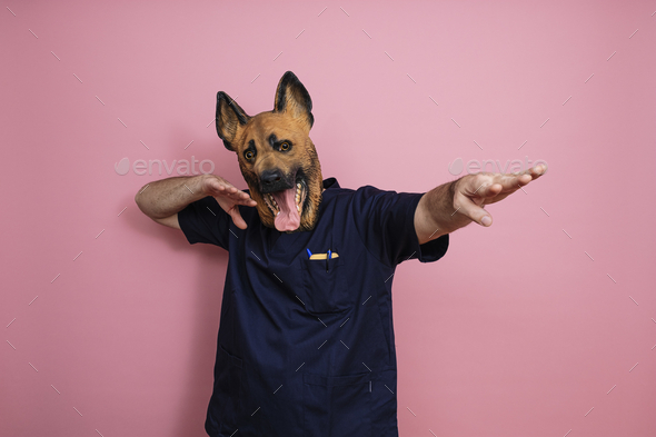 Young man in a latex dog head mask holding a weight scale on a pink  background Stock Photo - Alamy