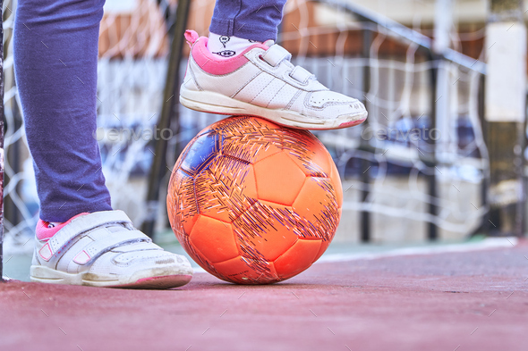 close up of the feet of a girl playing football  - Stock Photo - Images