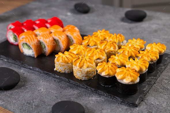 Sushi set. Philadelphia roll, california, unagi with fresh ingredients on black background. Sushi - Stock Photo - Images