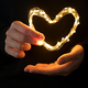 Hand holding heart made from lights - PhotoDune Item for Sale