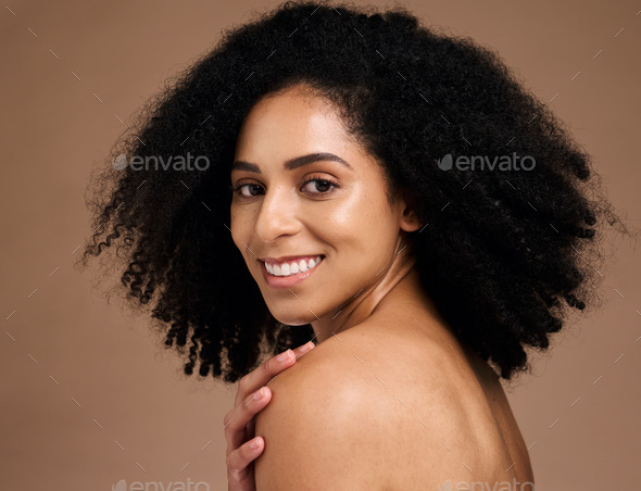 Happy woman, afro hairstyle and face skincare on studio background in self love hug, healthcare wel